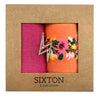 Socks in a box with a sparkly pin