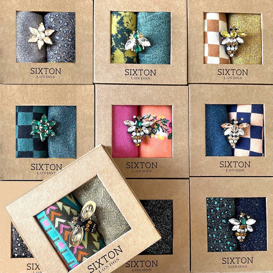 Socks in a box with a sparkly pin