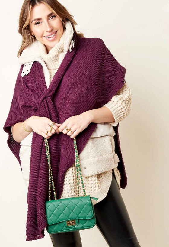 Knitted poncho in petrol