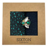 Socks in  box with a sparkly pin